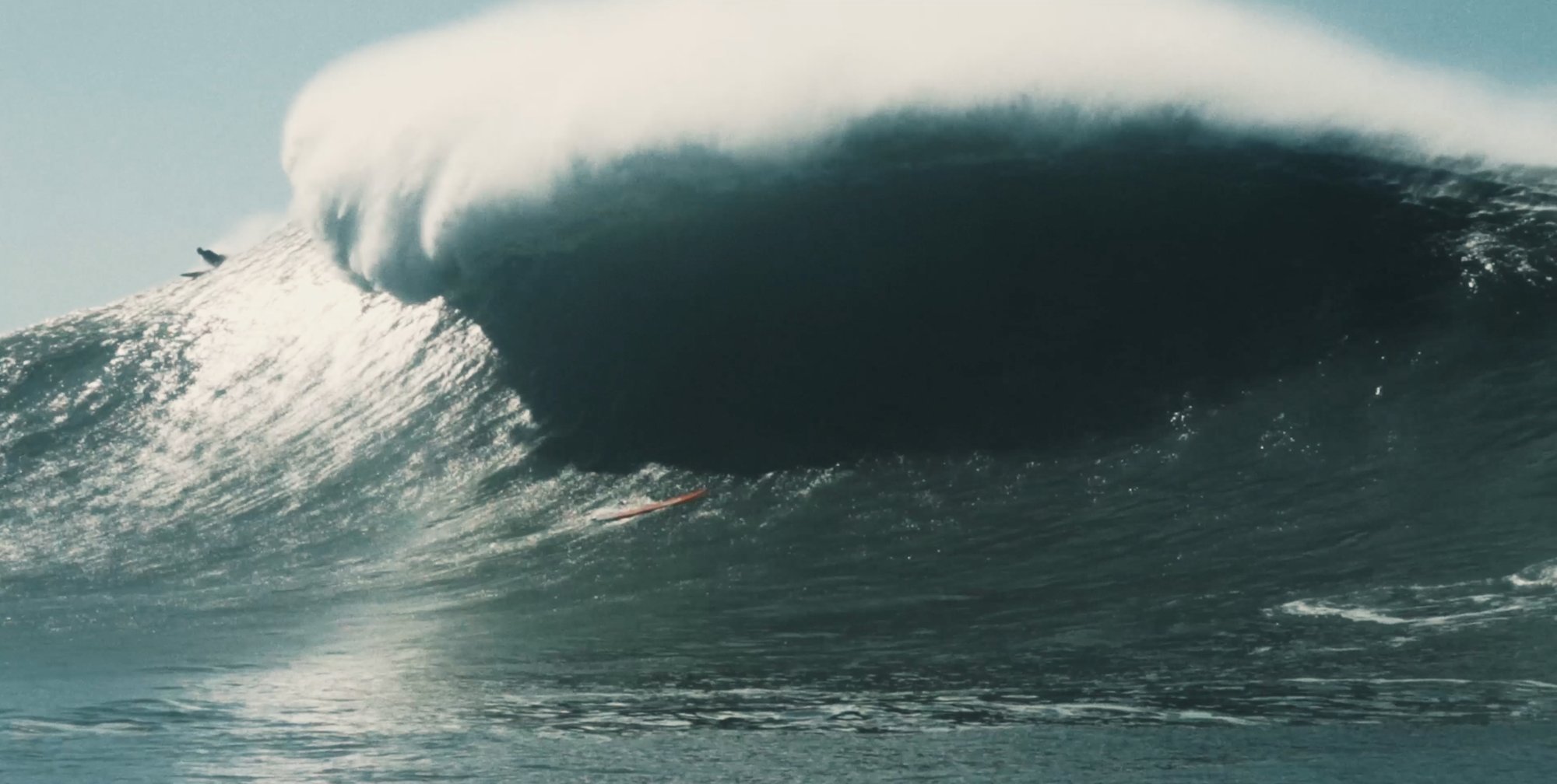 Marc Ebinger in front of a giant wave at Nazaré